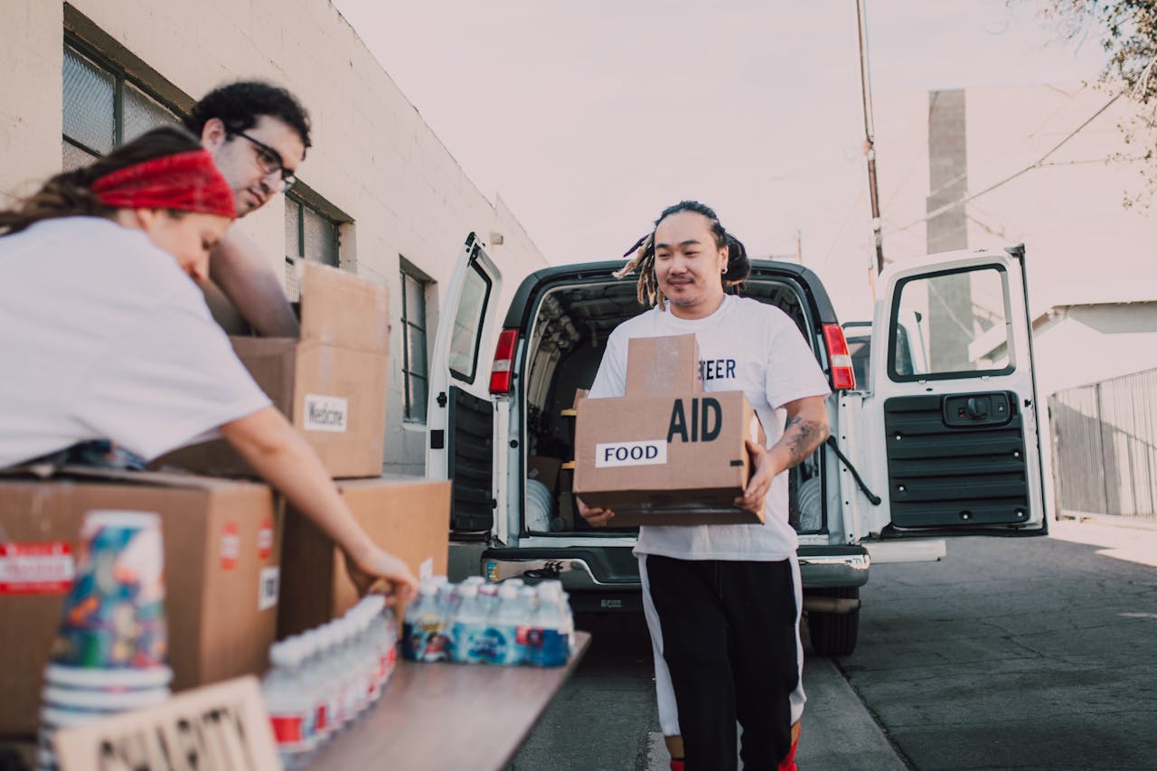 about-img Volunteers organizing and distributing aid from a van, supporting community efforts.